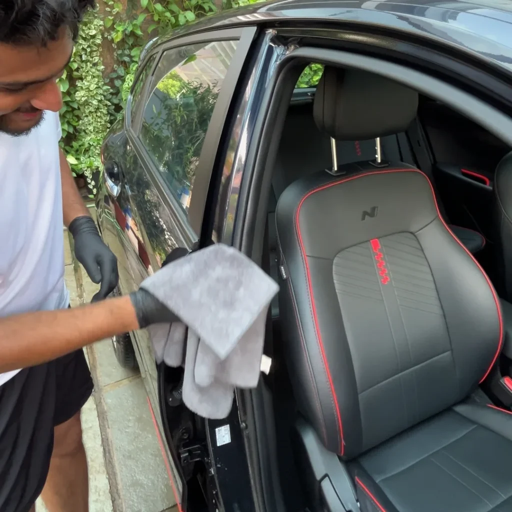 About 1 Expert technician performing interior deep cleaning on a Hyundai i20 N Line in Ernakulam.
